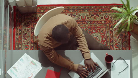 Top-Down-Portrait-of-African-American-Businessman-Working-in-Office